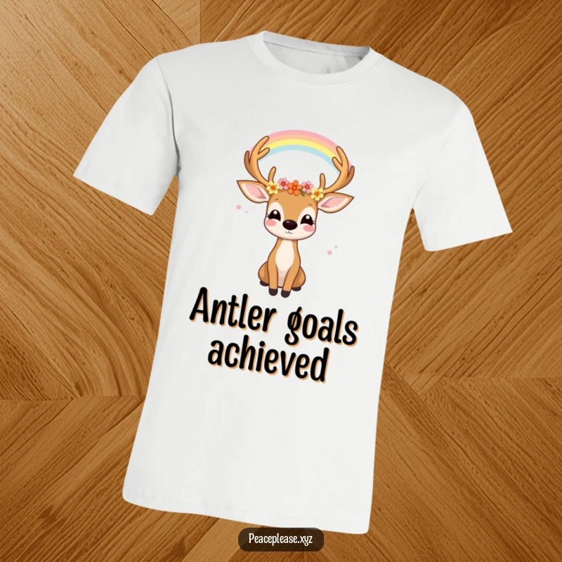 Funny t-shirt graphic of a joyful deer with flowers in its antlers gazing serenely at a rainbow, evoking peace.